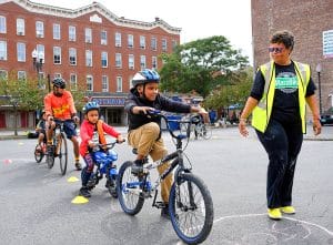 Safe Routes to School distributes free Project KidSafe helmets at the Lawrence Ciclovia.