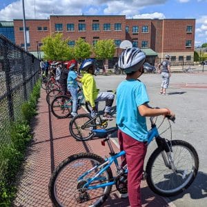 Project KidSafe in Lowell: Breakstone, White & Gluck gave each student at Stoklaska Middle School a free helmet to go with their new bike donated by The Bike Connector.